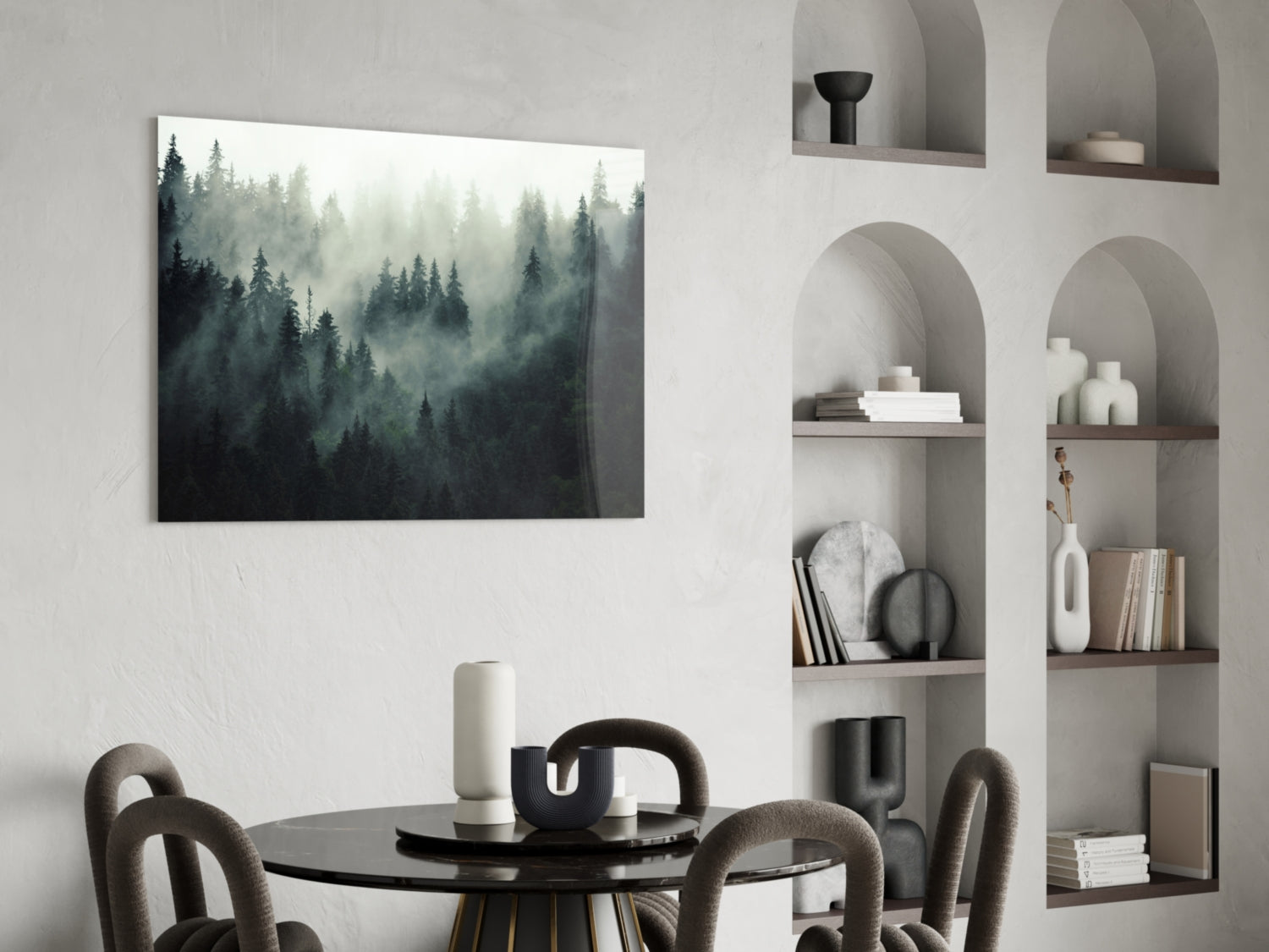 Misty forest landscape glass wall art displayed above black dining table with grey upholstered chairs.