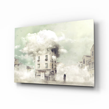 Glass wall art panel displaying a surreal urban street scene with dense fog, classical buildings, and a solitary figure, mounted at an angle showing depth and shadow.
