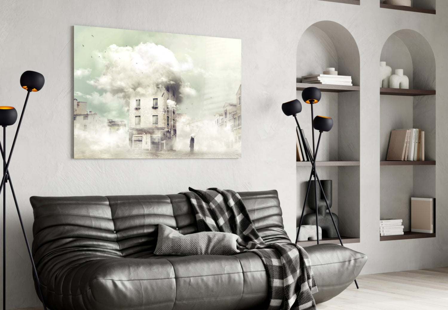 Fog Glass Wall Art displaying a misty urban street scene with buildings and clouds, displayed above a black leather sofa in a modern living room interior.