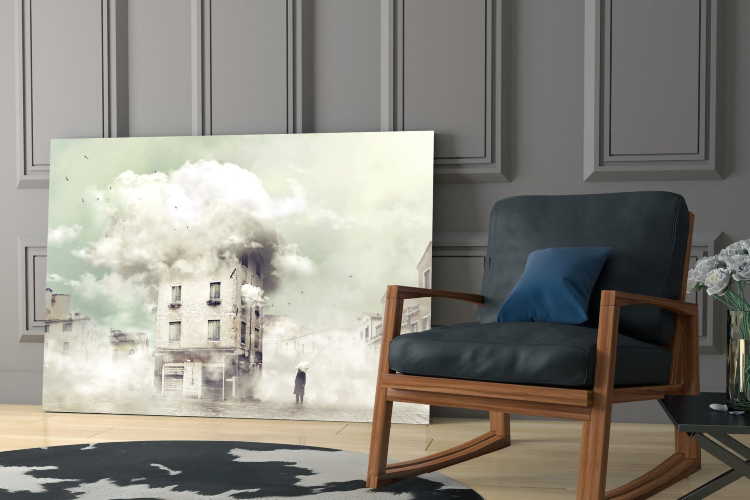 Glass wall art depicting a surreal foggy urban scene with a solitary figure and ethereal clouds, displayed in a modern interior with mid-century wooden chair.