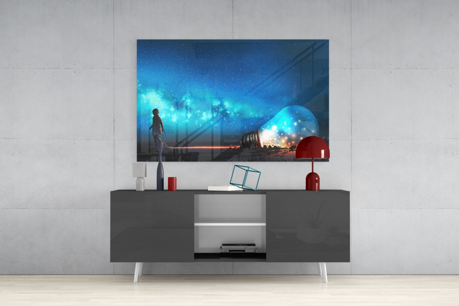 Starry Night Glass Wall Art mounted above gray media console, displaying glowing blue cityscape with figure and illuminated lightbulb against night sky.