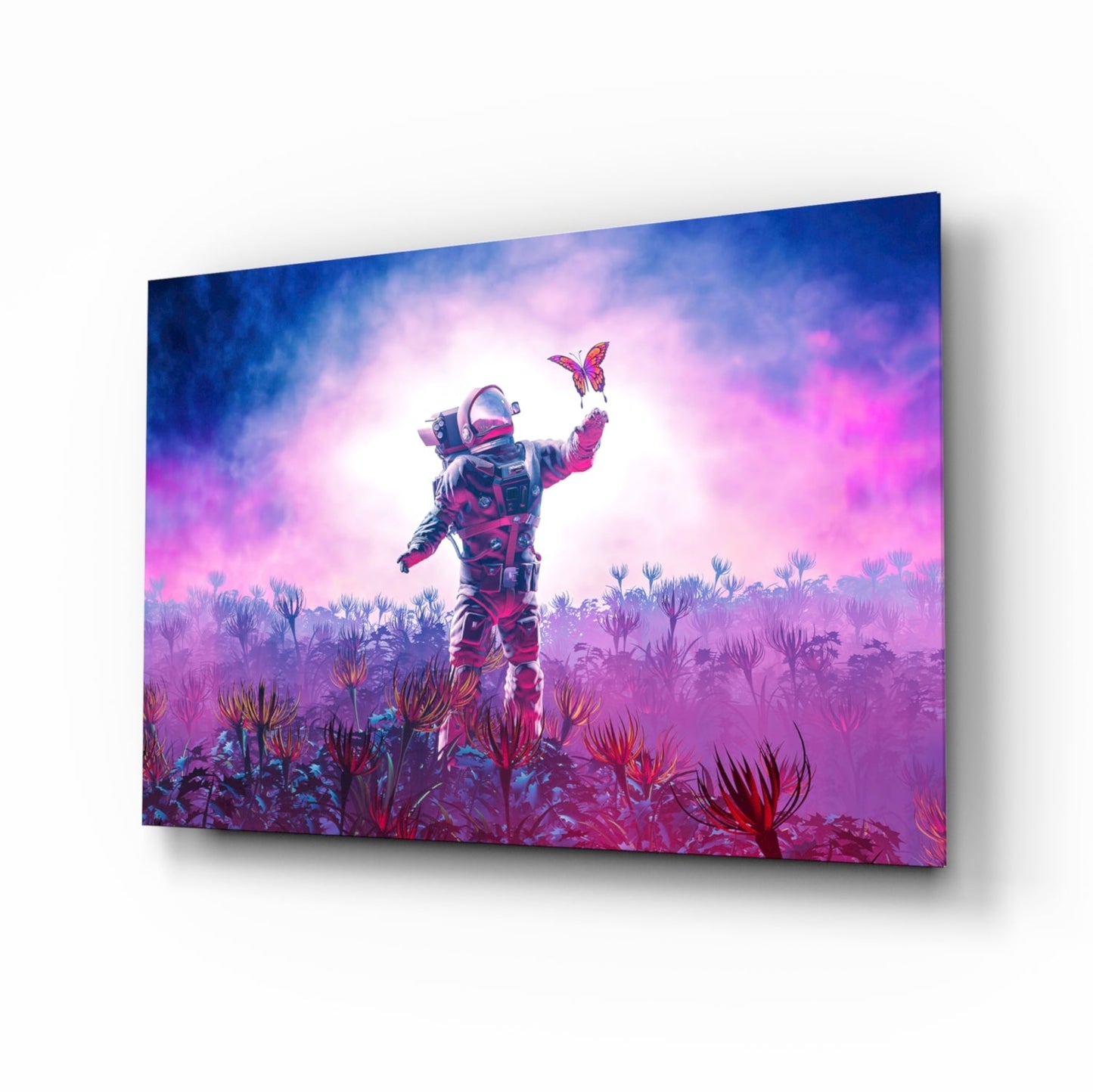 Angled view of glass wall art showing an astronaut in a spacesuit with raised arm catching a butterfly, surrounded by purple and pink alien flowers against a luminous sky.