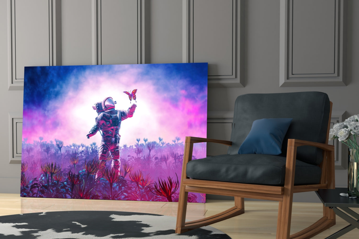 Glass wall art displaying an astronaut in a colorful pink and blue alien landscape with butterflies, installed in a modern living room.