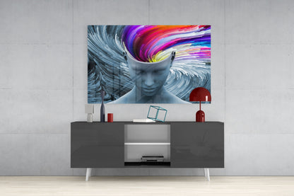 Gray glass wall art depicting a silhouetted head with colorful swirling patterns displayed above a dark console table in modern interior setting.