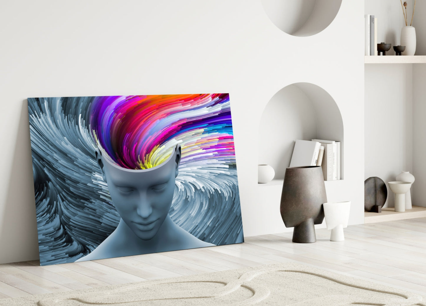 Colorful glass wall art leaning against white wall displays abstract blue head silhouette with vibrant rainbow swirls inside.