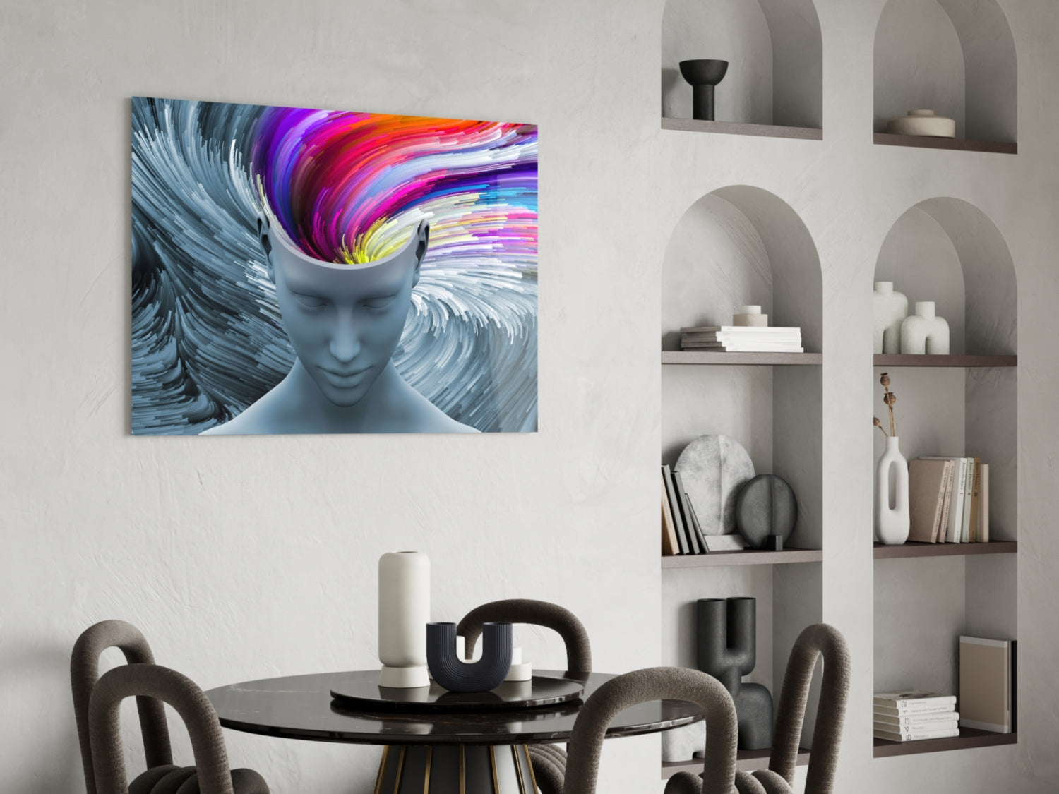 Colorful glass art depicting a blue-grey human head with rainbow swirling patterns inside, displayed above a dining table in a modern interior.