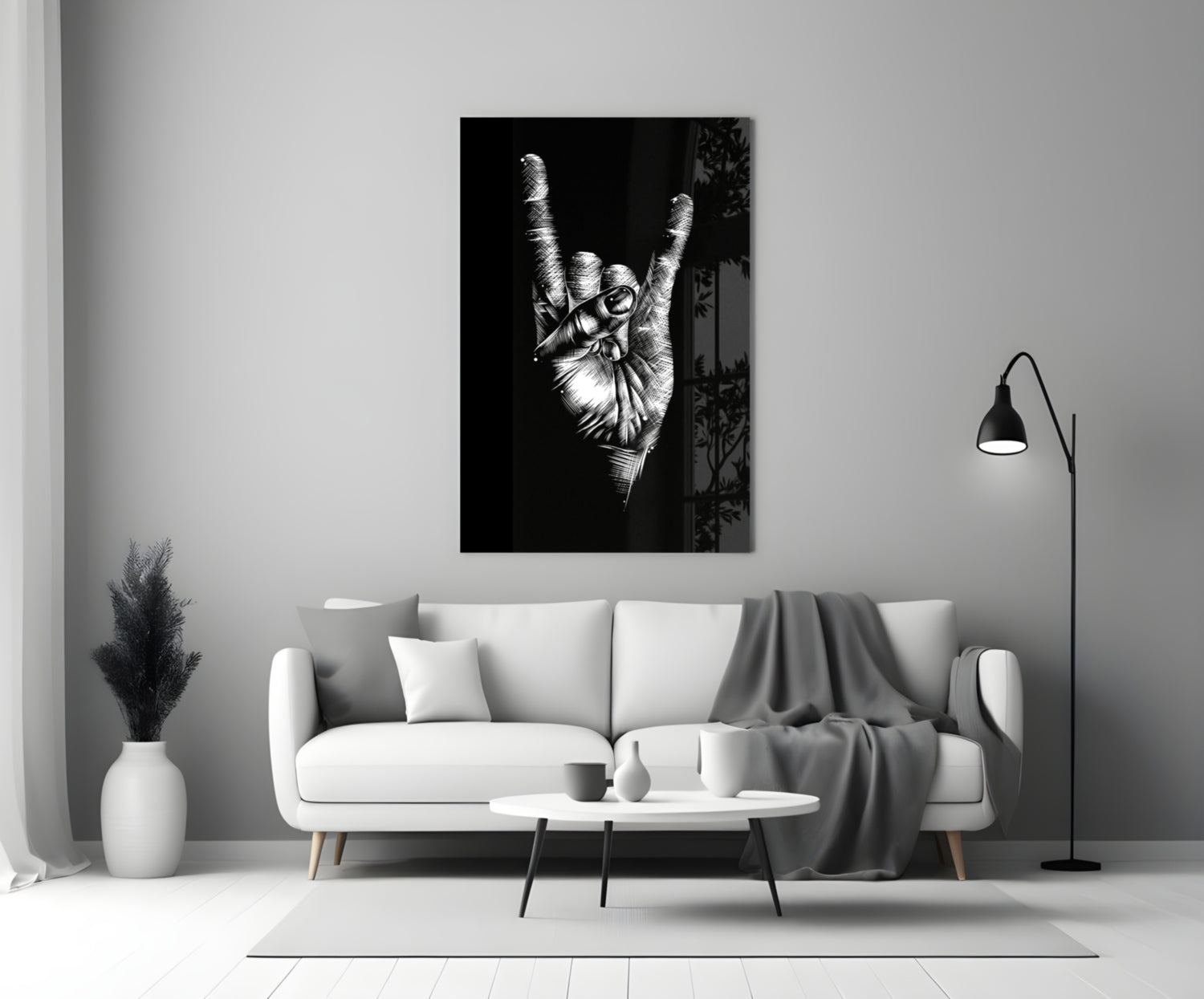 Black and white glass wall art depicting a hand making a peace sign gesture, displayed above a white sofa in a minimalist living room.