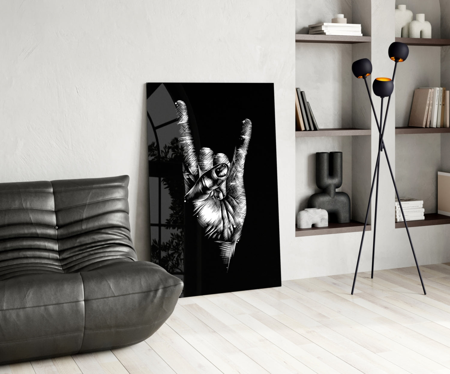 Black and white glass wall art depicting a hand making a peace sign, displayed in a modern living room with gray sofa and shelving.