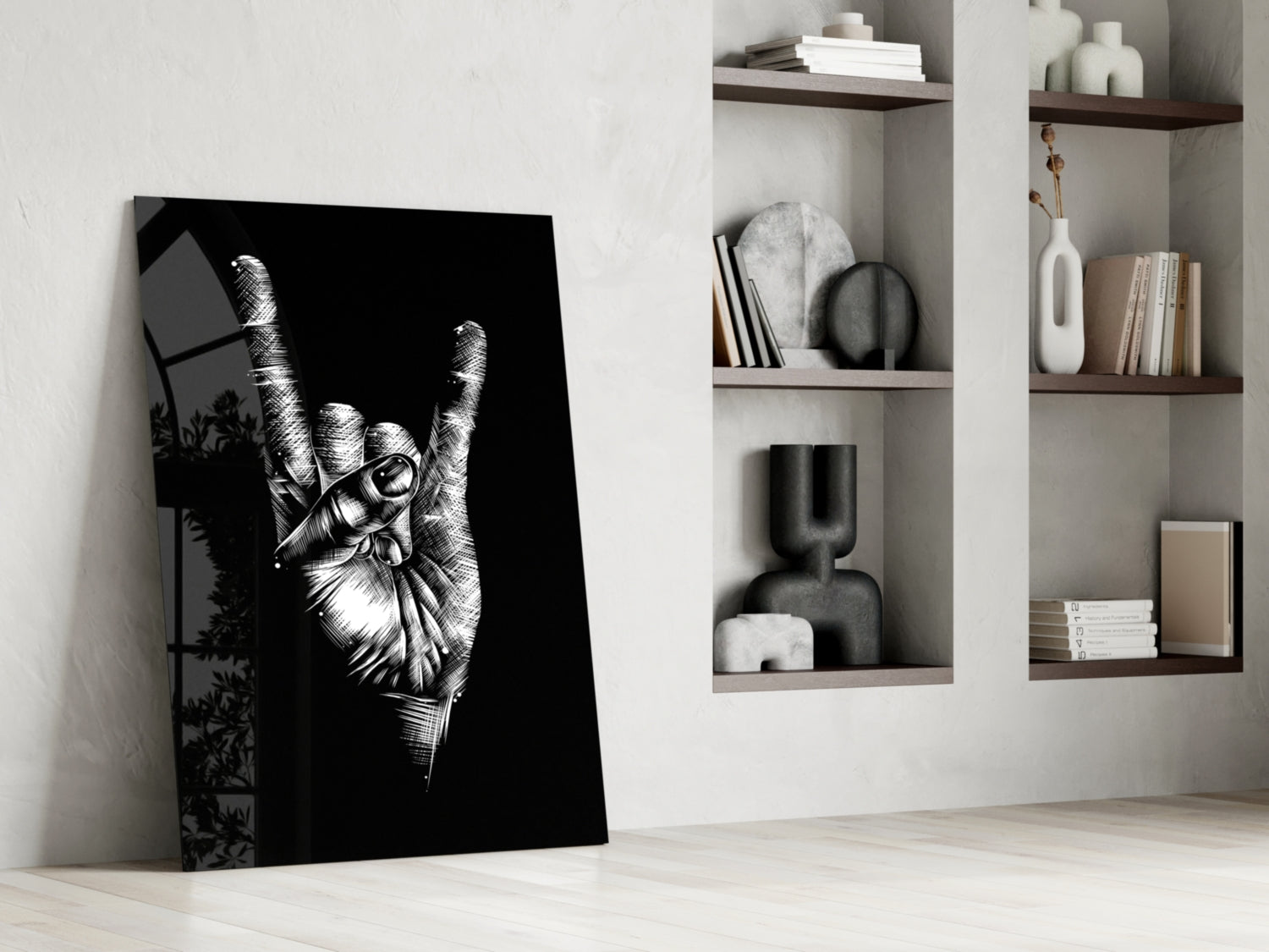 Black and white glass art leaning against white wall showing detailed hand making peace sign gesture.