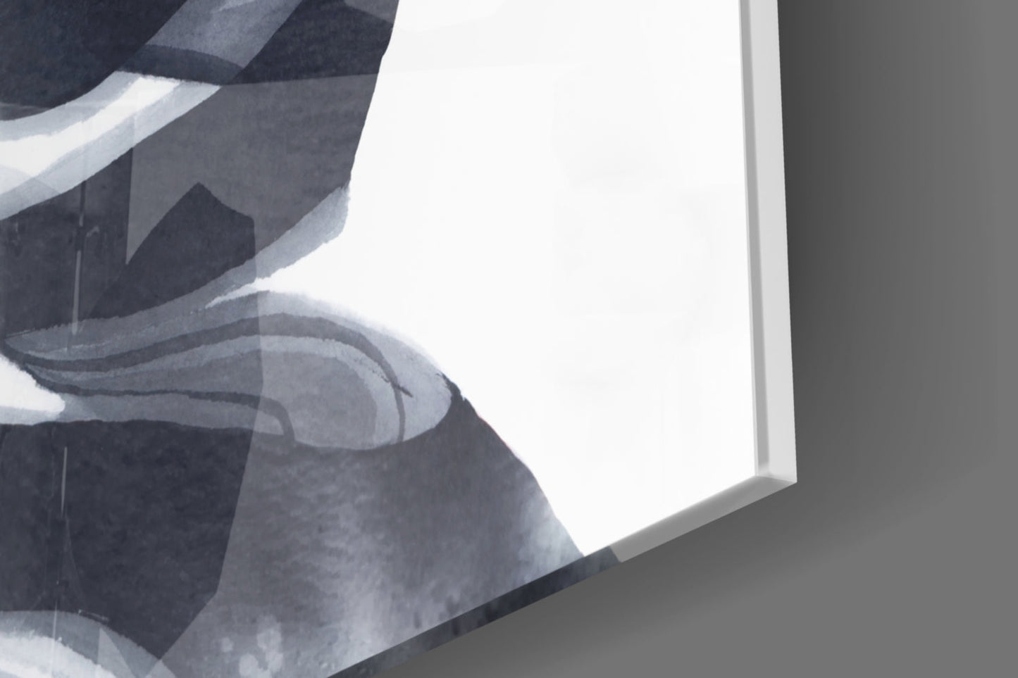 Close-up angled view of frosted glass wall art panel showing abstract monochromatic design with curved shapes and white border.
