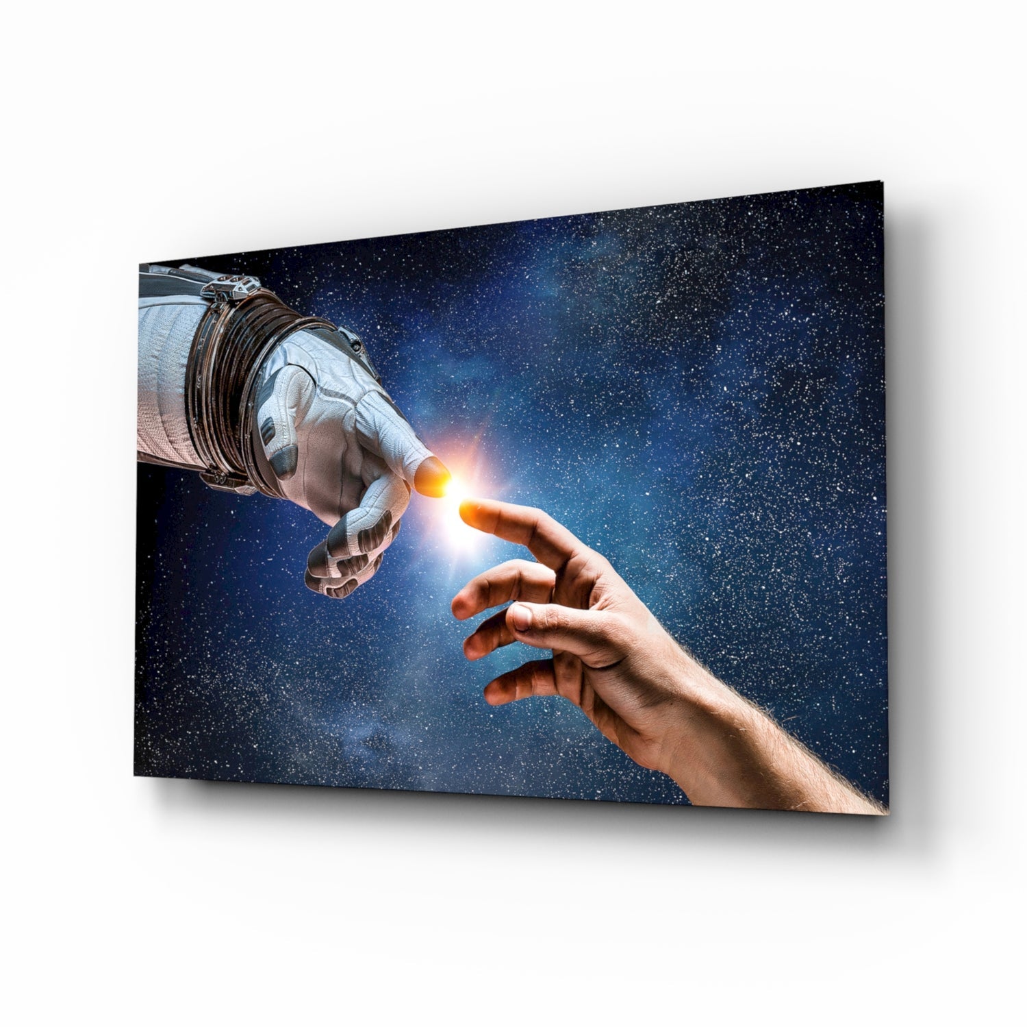 Angled view of glass wall art depicting an astronaut's gloved hand touching a human hand against a starry blue space background.