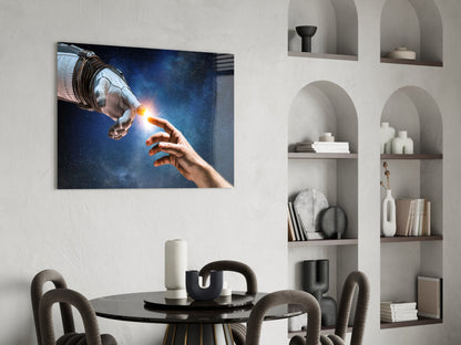 Spaceman and human hand touching with glowing light against starry blue space background on glass wall art displayed above dining table.