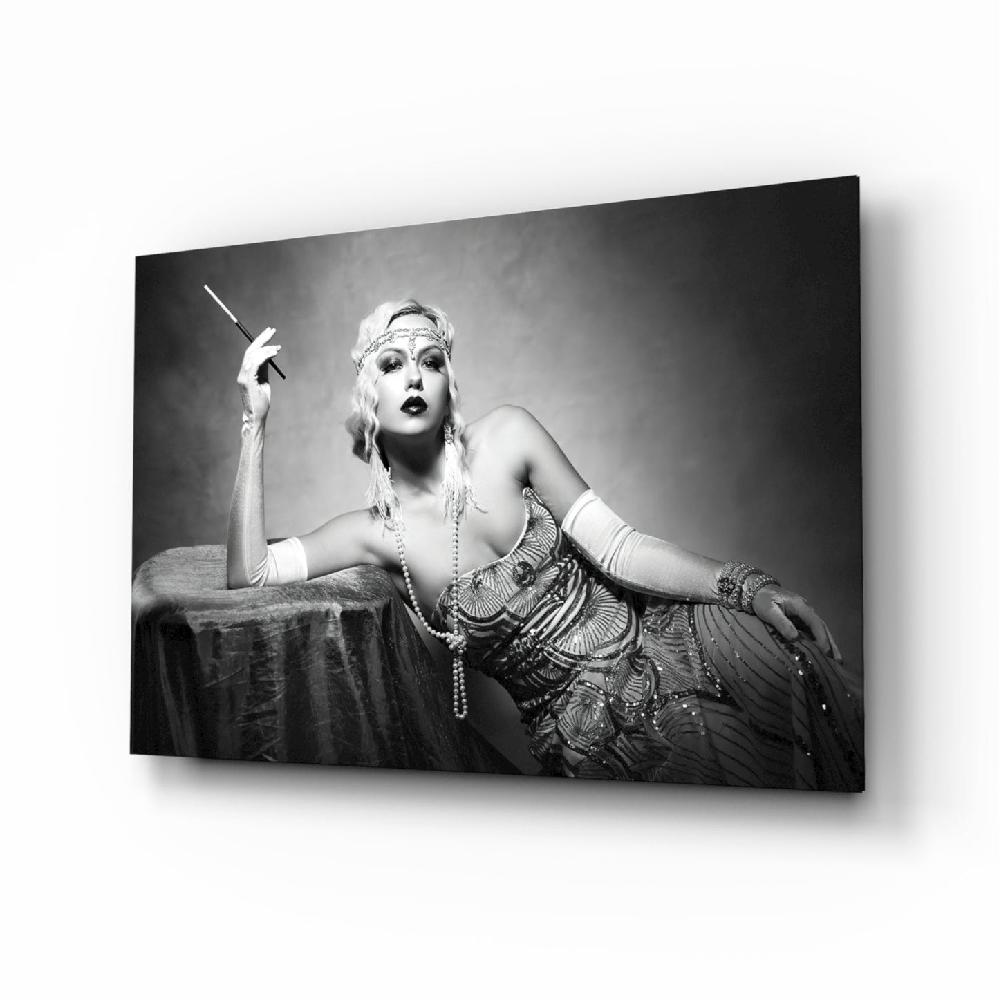 Black and white photograph of a woman in 1920s attire holding a cigarette holder, displayed as a framed glass wall art print.