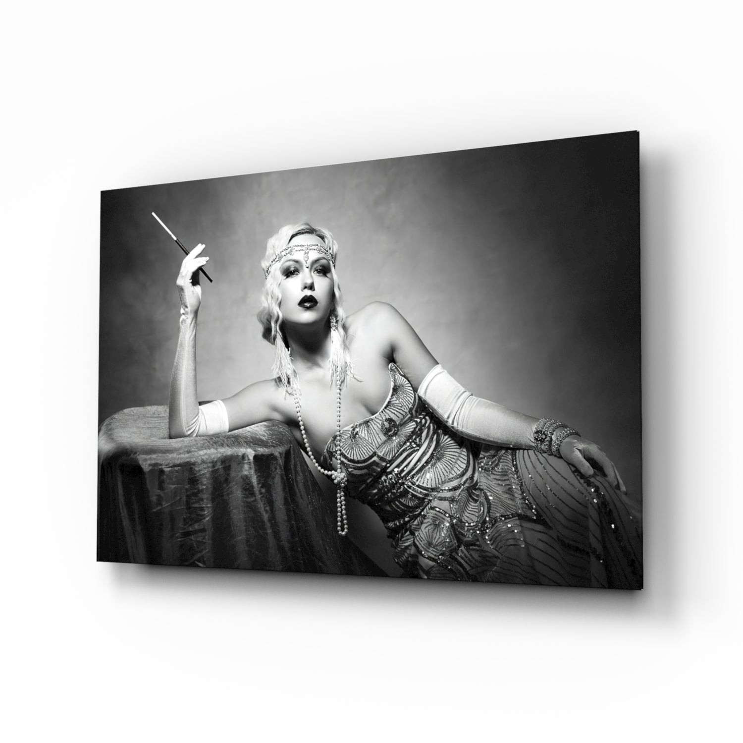 Black and white photograph of a woman in 1920s attire holding a cigarette holder, displayed as a framed glass wall art print.