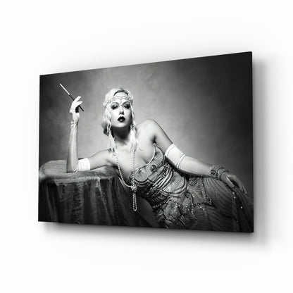 Black and white photograph of a woman in 1920s attire holding a cigarette holder, displayed as a framed glass wall art print.