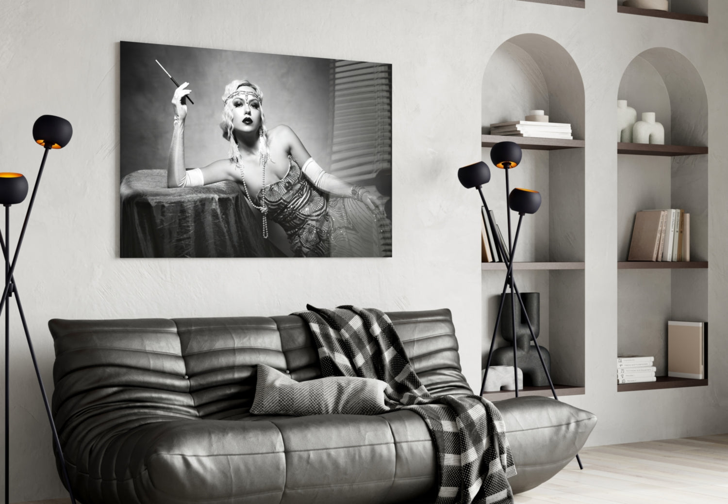 Black and white glass wall art depicting a 1920s woman with cigarette holder displayed above a leather sofa in modern interior.