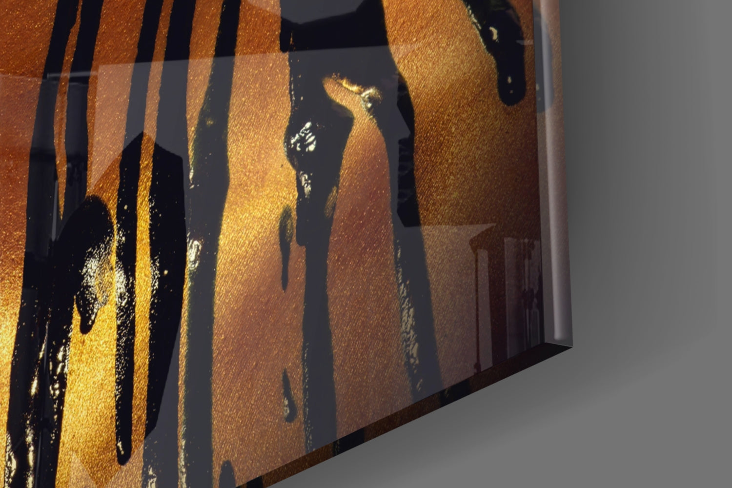 Stained glass wall art with golden and black vertical striped pattern displayed at an angle, showing textured glass surface and shadow cast on white wall.