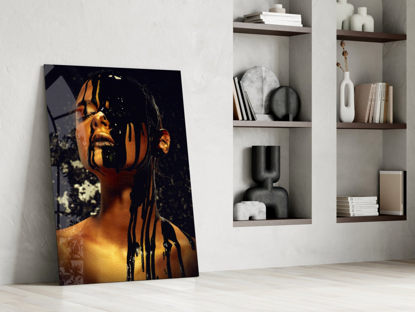 Portrait stain glass wall art leaning against white wall beside shelving unit, showing golden-lit face with black dripping paint effect.