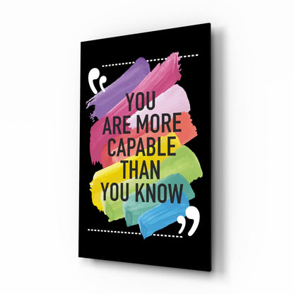 Black glass wall art with colorful watercolor brushstrokes and motivational text "You Are More Capable Than You Know" displayed at an angled perspective.