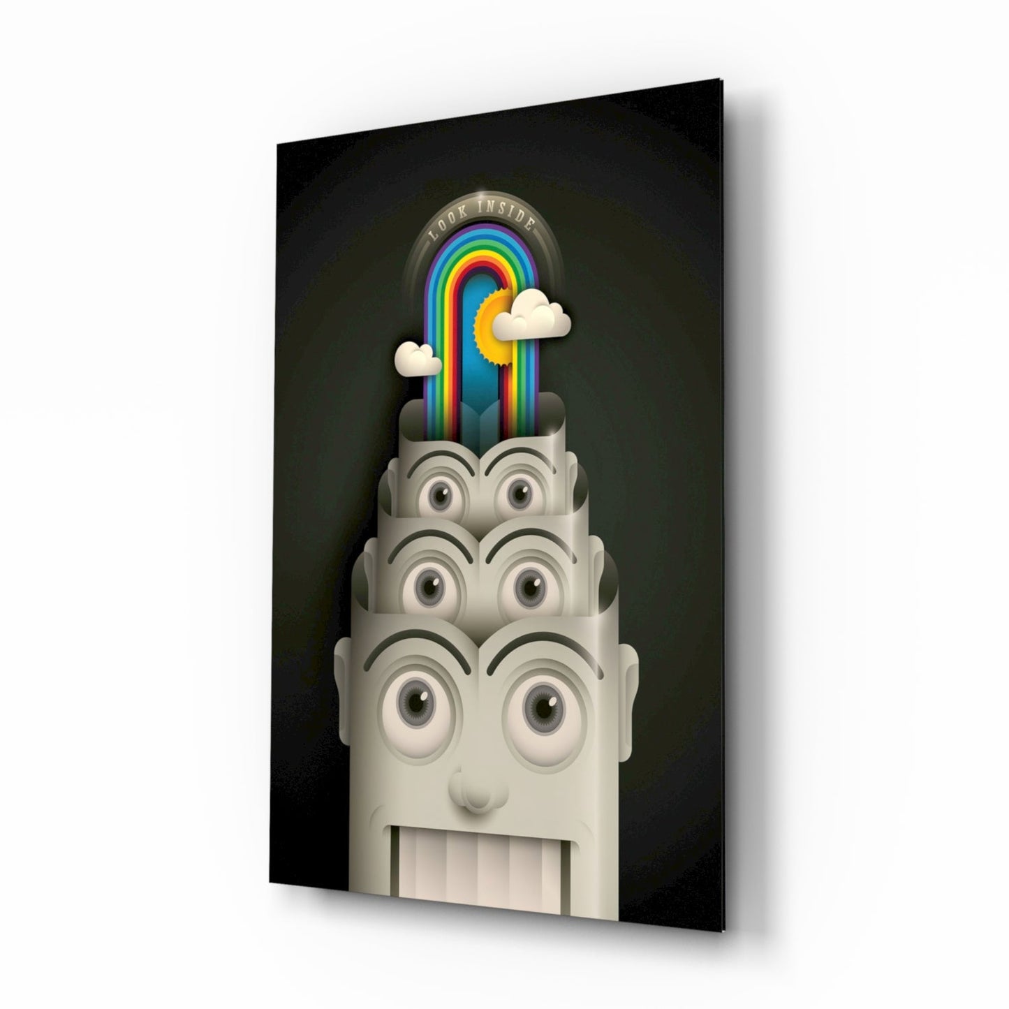 Angled view of glass wall art featuring a cream-colored sculptural head with stacked eyes, containing a rainbow and clouds, against dark background.