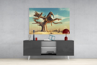 Thinking Elephant Glass Wall Art displayed above a dark gray media console, showing a desert landscape with an elephant perched on a gnarled tree against a turquoise sky.