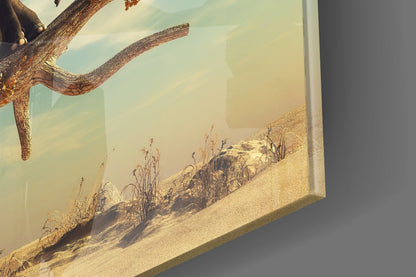 Close-up angled view of glass art showing textured tree branch and desert landscape with sand, water, and vegetation in warm earth tones.
