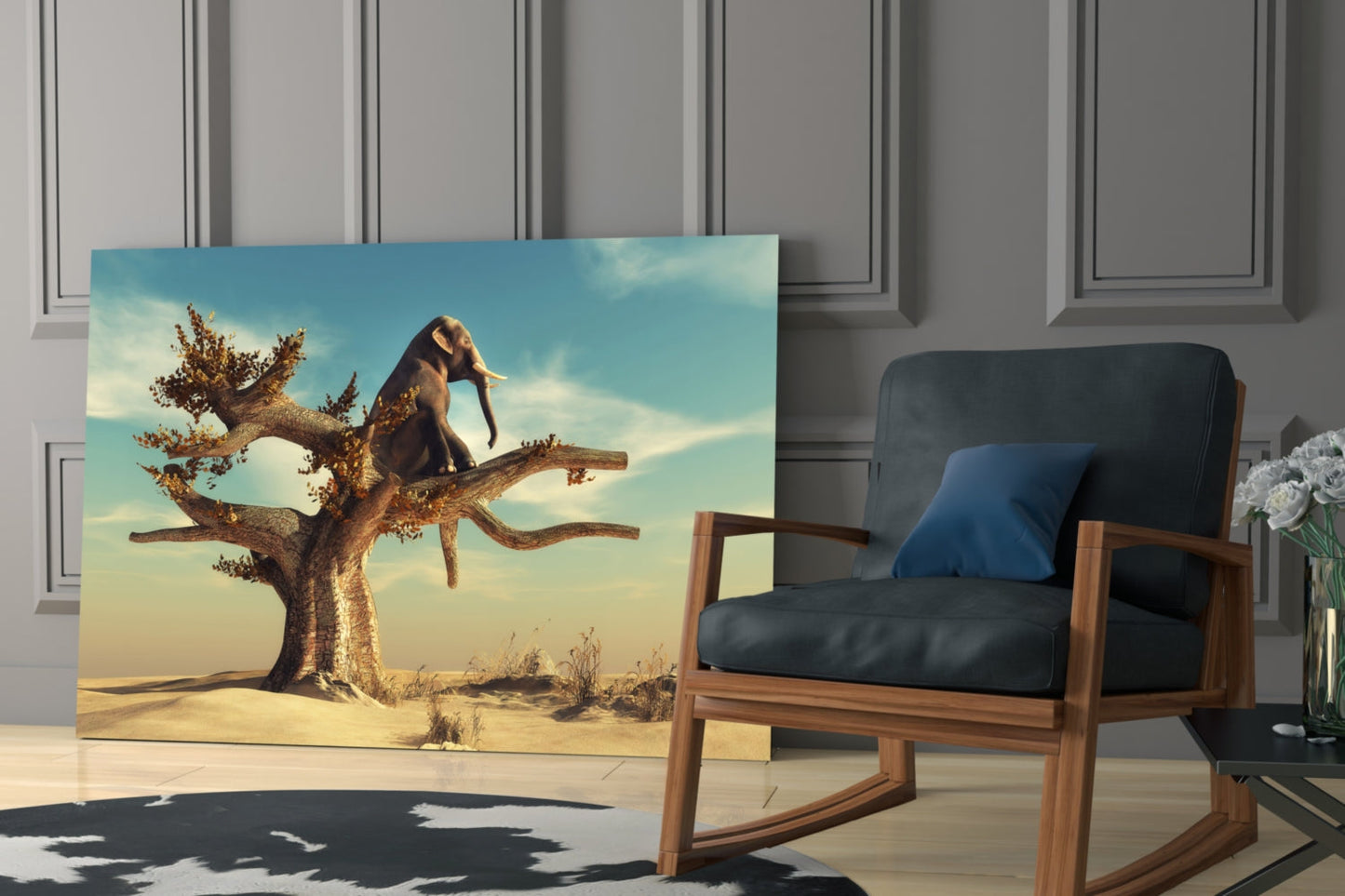 Glass wall art depicting an elephant balancing on a gnarled tree branch in a desert landscape with blue sky, displayed in a modern living room next to a wooden chair.