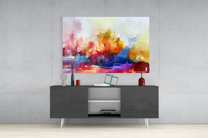 Colorful abstract watercolor landscape artwork with pink, yellow, orange, and blue tones displayed above a dark gray media console in a modern interior setting.