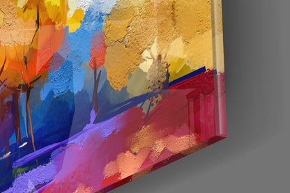 Angled view of colorful glass wall art featuring layered blue, red, yellow, and purple paint with tree silhouettes and textured surfaces.