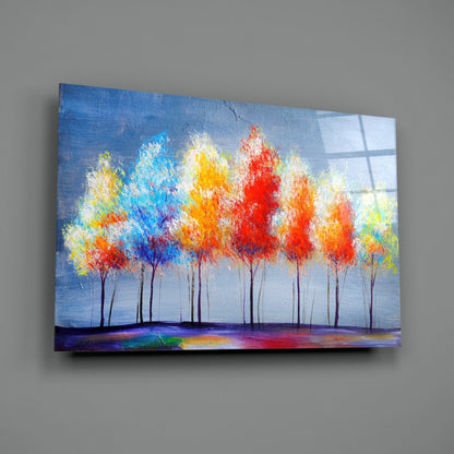 Colorful abstract tree painting on glass panel mounted on gray wall, featuring vibrant red, blue, yellow, and orange foliage against blue sky background.