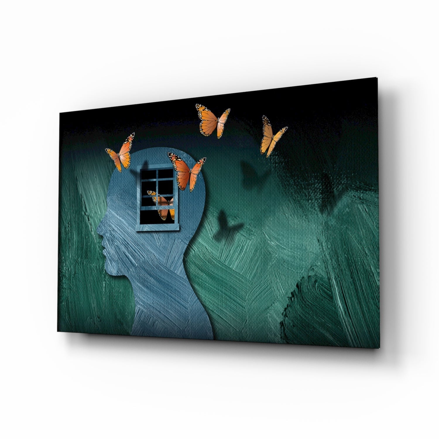 Glass wall art featuring silhouetted head profiles with orange monarch butterflies emerging from a window, teal and blue brushstroke background.