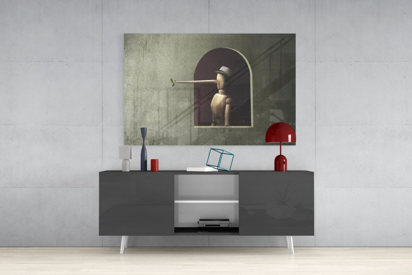 Pinocchio Glass Wall Art displayed above gray media console with white center shelving, red decorative objects, and blue geometric sculpture.