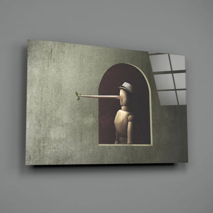 Wooden figure with extended nose holding small green leaf, viewed through arched window opening in textured green wall panel with gridded window frame.