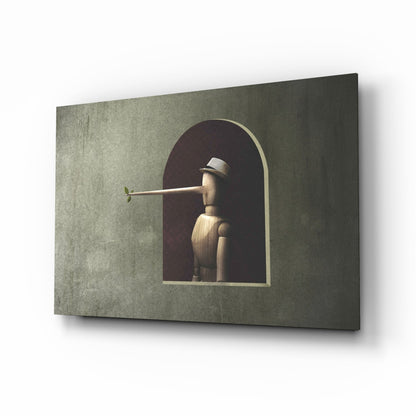 Wooden Pinocchio figure with extended nose displayed in arched niche on textured sage green glass panel, angled three-quarter view.