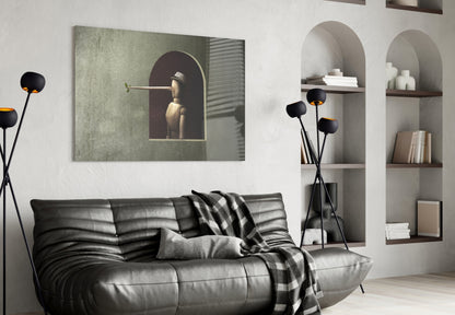 Modern living room with Pinocchio Glass Wall Art displayed above black leather sofa, featuring surreal portrait in green tones.