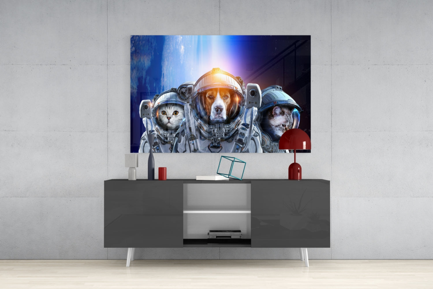 Glass wall art mounted above gray media console displays three animals in astronaut suits against a cosmic blue background with glowing light.