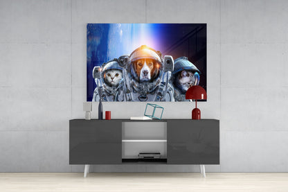 Glass wall art mounted above gray media console displays three animals in astronaut suits against a cosmic blue background with glowing light.