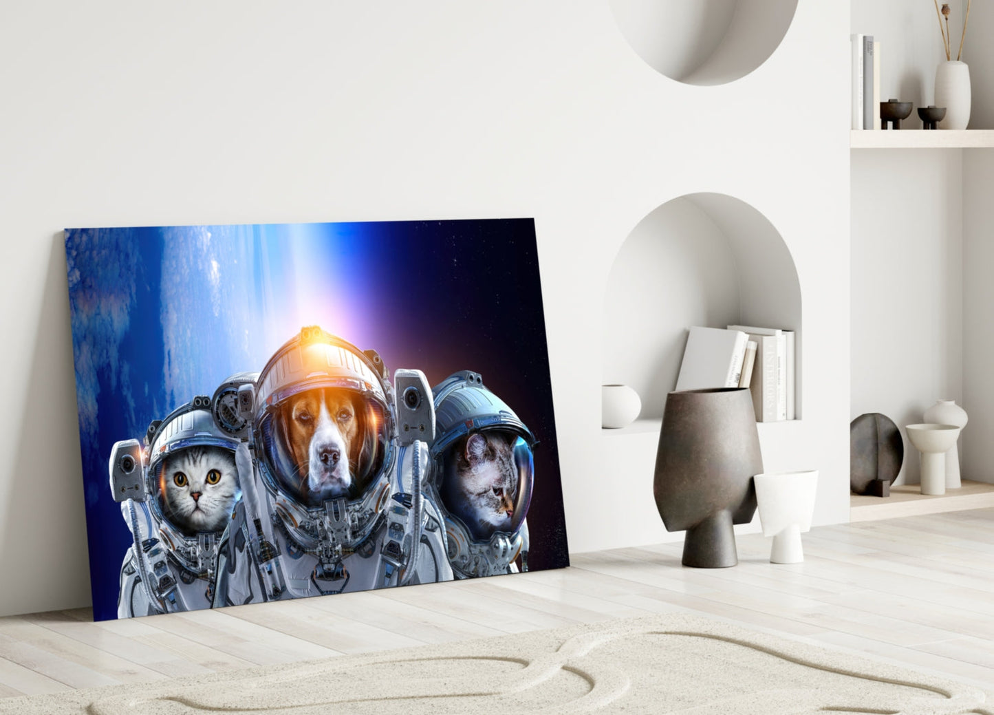 Space Team Glass Wall Art leaning against white wall in minimalist interior, showing three astronauts with glowing helmets against blue cosmic background.