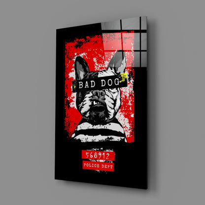 Angled perspective view of black glass wall art featuring a stylized French Bulldog mugshot with red background, "Bad Dog" text, and police identification number.