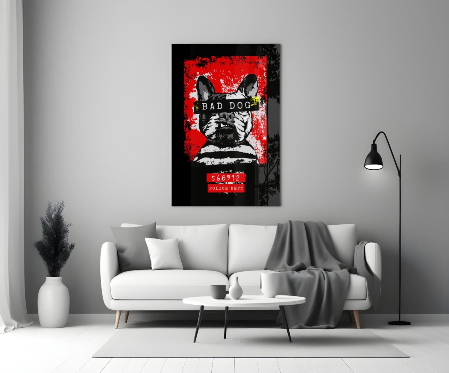 Bad Dog" glass wall art hung above white sofa in modern living room, displaying black and white French Bulldog with red background and police mugshot text.