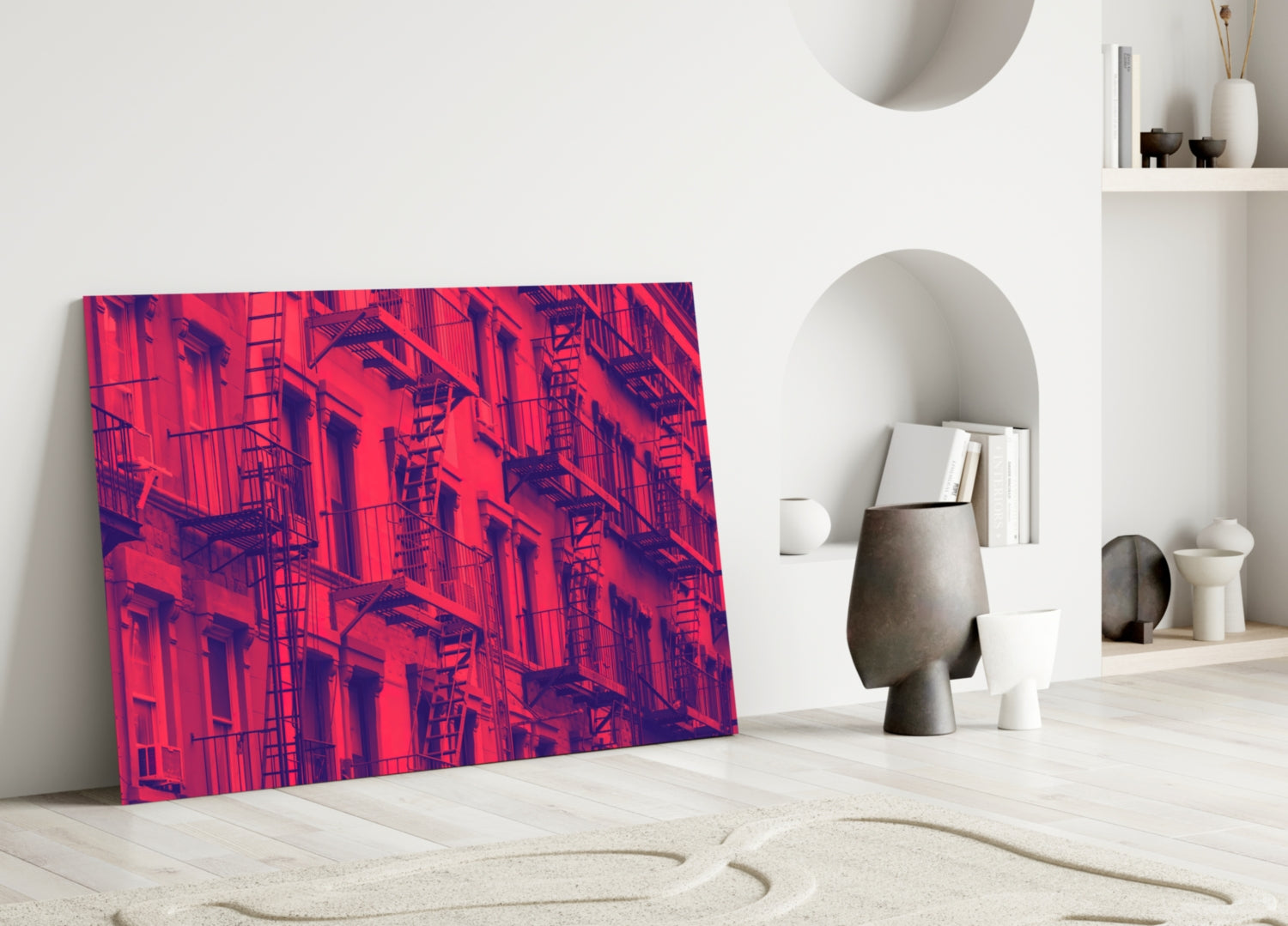 Vibrant red and purple thermal-style urban building facade glass wall art leaning against white interior wall.
