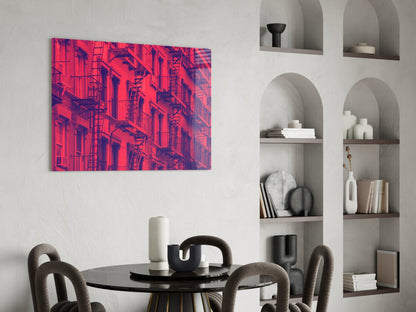 Vibrant neon pink and purple architectural fire escape glass wall art displayed above a dining table.