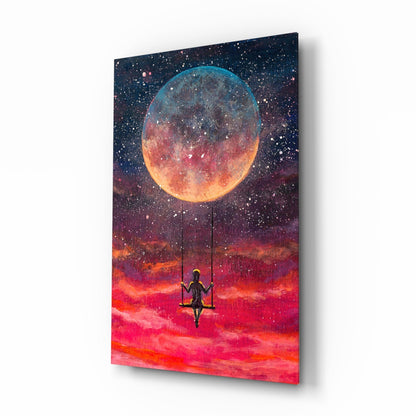 Canvas wall art depicting a silhouetted figure on a swing beneath a glowing moon against a fiery red and orange sky.