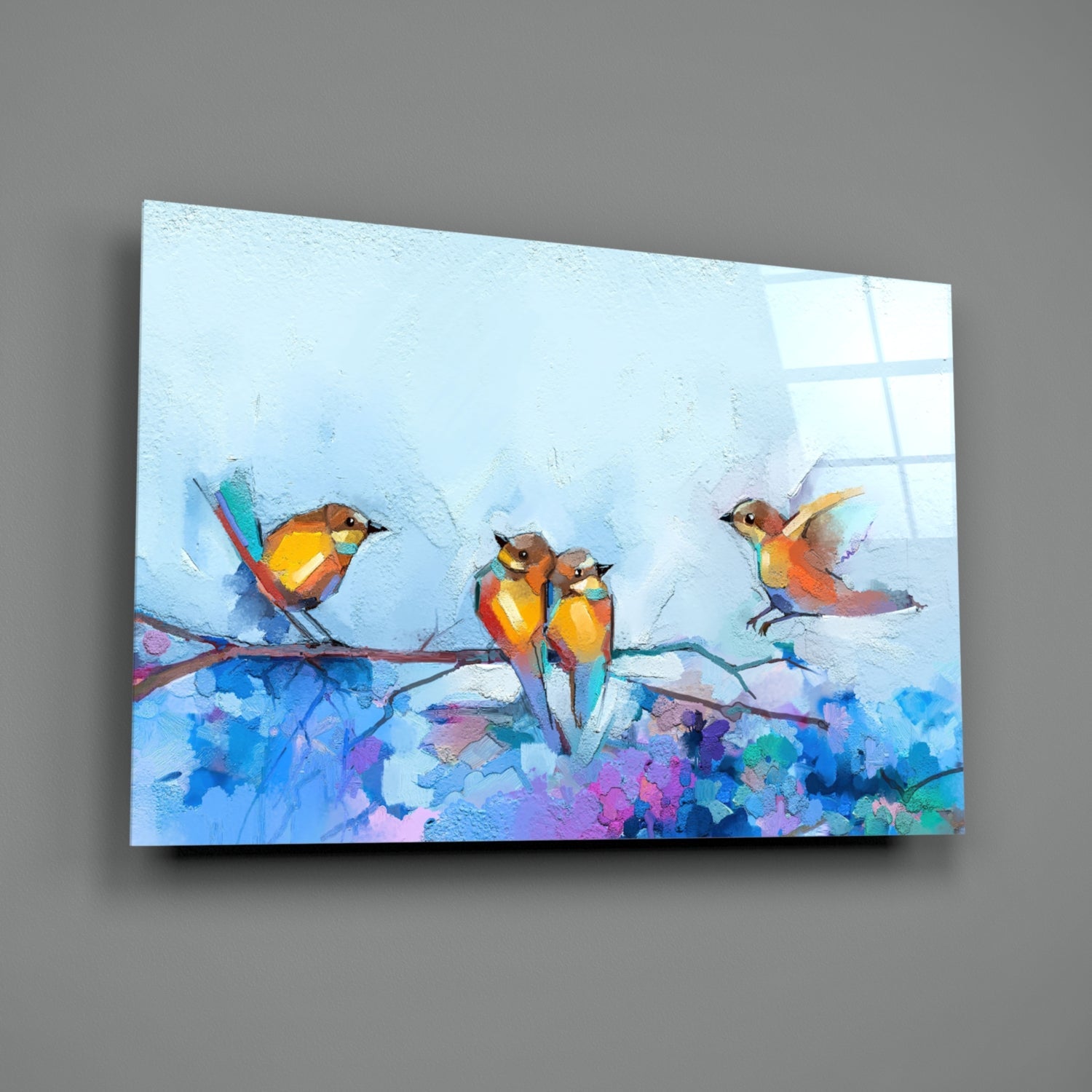 Colorful glass wall art depicting three orange and yellow birds perched on a branch with vibrant blue and purple floral elements against a light blue background.