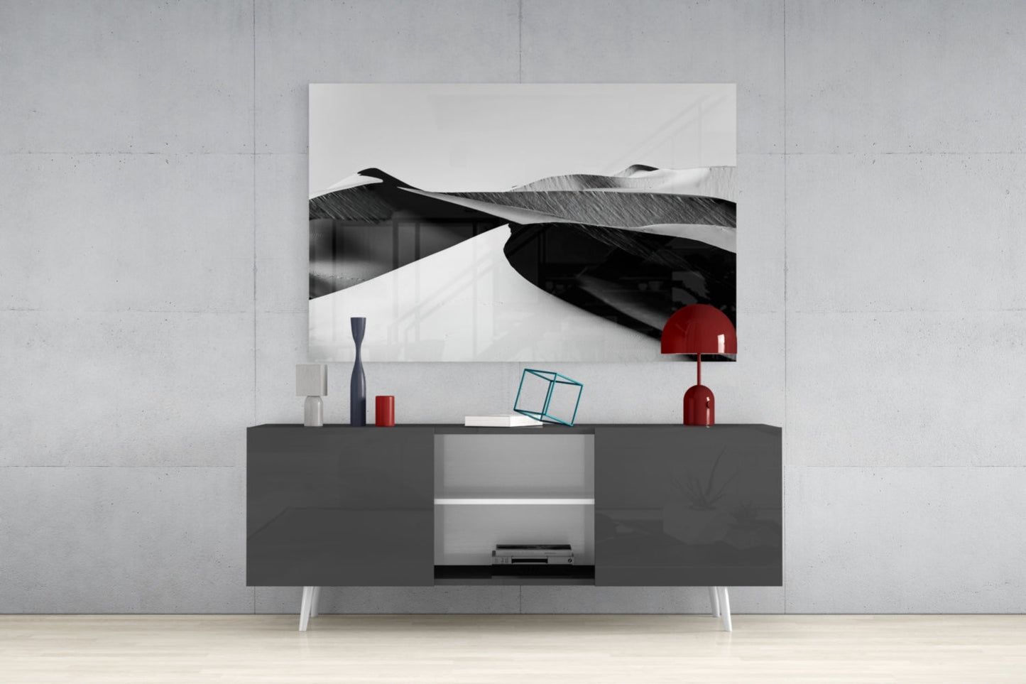 Black and white glass landscape artwork displayed above a dark gray media console with red decorative accents.