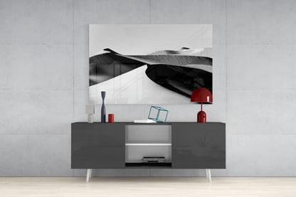 Black and white glass landscape artwork displayed above a dark gray media console with red decorative accents.