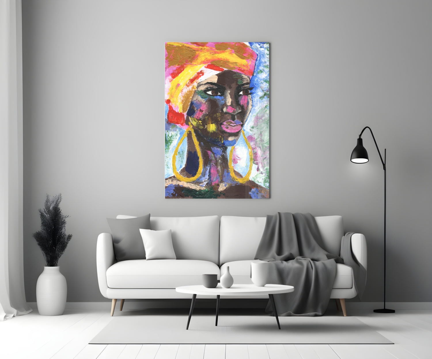 Colorful abstract portrait of a woman with gold earrings displayed on white wall above modern sofa in minimalist living room.