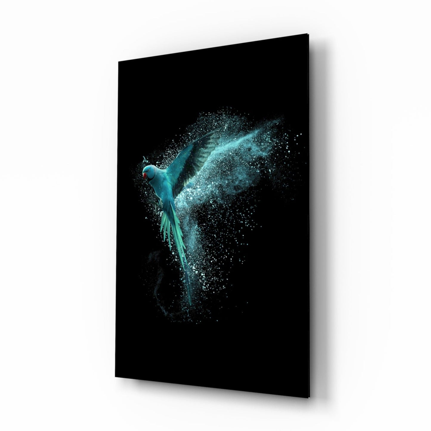 Turquoise parrot with dispersing particle trail displayed on black glass panel, angled view showing right side and shadow edge.