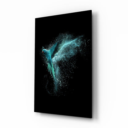 Turquoise parrot with dispersing particle trail displayed on black glass panel, angled view showing right side and shadow edge.