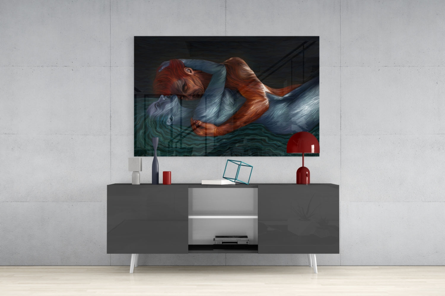 Modern living room with glass wall art depicting a red-haired figure above a dark gray media console with white legs and decorative accessories.